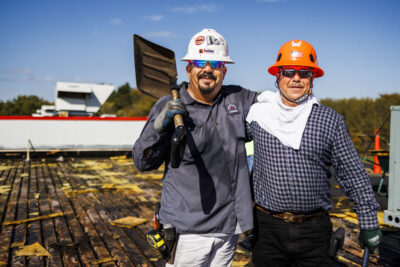 two turner roofing employees work on repairing a commercial roof