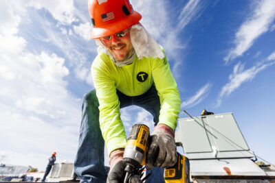 turner roofing employee performs roof maintenance on a commercial business roof